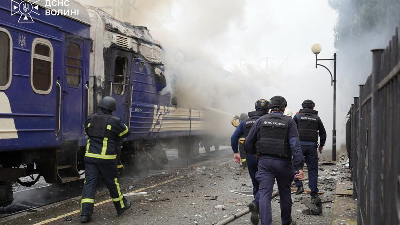 This handout picture taken and released by the Ukrainian State Emergency Service on September 12, 2026 shows firefighters extinguish fire at a train carriage damaged by a drone strike near the border with Poland. Poland and Ukraine condemned on September 13, 2026 an escalation following Russian strikes in Ukraine close to the Polish border, which notably targeted a train bound for Warsaw, which come just a week after visits by US envoys to Moscow and Kyiv aimed at reviving Washington-led negotiations to end the conflict. (Photo by Handout / Ukrainian State Emergency Service / AFP) HANDOUT