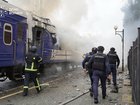 This handout picture taken and released by the Ukrainian State Emergency Service on September 12, 2026 shows firefighters extinguish fire at a train carriage damaged by a drone strike near the border with Poland. Poland and Ukraine condemned on September 13, 2026 an escalation following Russian strikes in Ukraine close to the Polish border, which notably targeted a train bound for Warsaw, which come just a week after visits by US envoys to Moscow and Kyiv aimed at reviving Washington-led negotiations to end the conflict. (Photo by Handout / Ukrainian State Emergency Service / AFP) HANDOUT