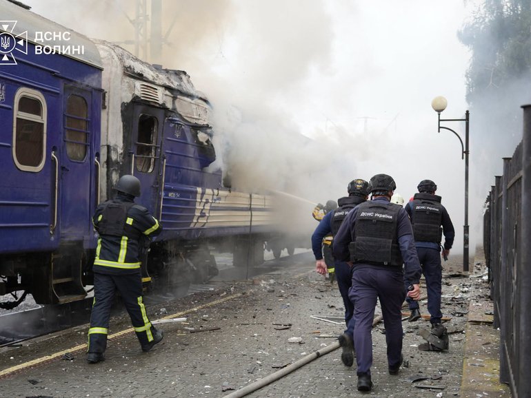 This handout picture taken and released by the Ukrainian State Emergency Service on September 12, 2026 shows firefighters extinguish fire at a train carriage damaged by a drone strike near the border with Poland. Poland and Ukraine condemned on September 13, 2026 an escalation following Russian strikes in Ukraine close to the Polish border, which notably targeted a train bound for Warsaw, which come just a week after visits by US envoys to Moscow and Kyiv aimed at reviving Washington-led negotiations to end the conflict. (Photo by Handout / Ukrainian State Emergency Service / AFP) HANDOUT
