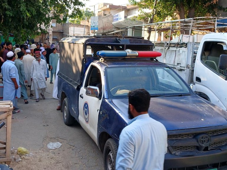 Security officials stand guard near the scene of a bombing at a mosque in Kohat, Pakistan. (EPA PHOTO)