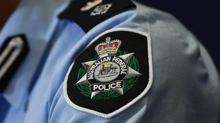 Australian Federal Police officers have arrested a man  accused of being an Islamic State operative. (Jono Searle/AAP PHOTOS)