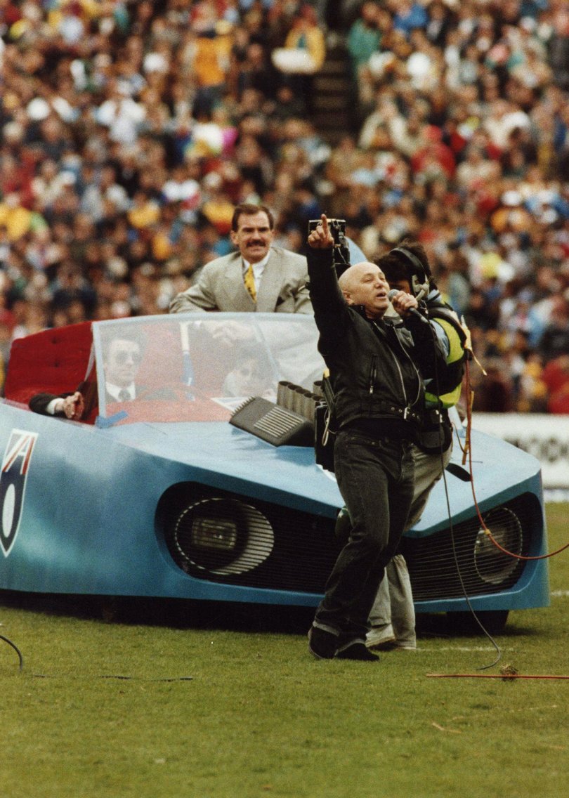 Angry Anderson performs with the Batmobile at Waverley Park Football Stadium during the AFL Grand Final between the West Coast Eagles and Hawthorn Hawks, 28 September 1991.
THE AGE Picture by STAFF
