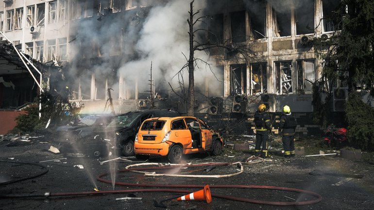 Ukrainian rescuers extinguish a fire in an office building following an air attack on  Kyiv on Wednesday.