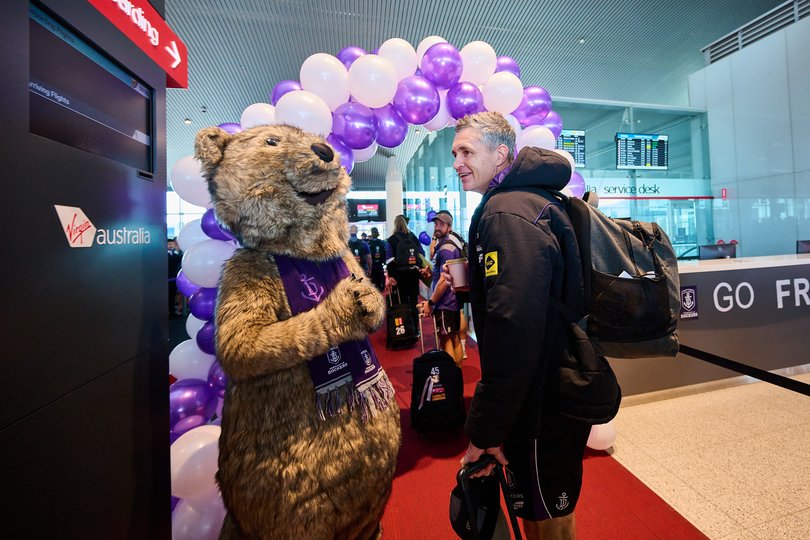 Justin Longmuir, Senior Coach of the Dockers walks to board the plane.