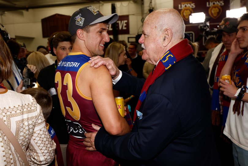 Zac Bailey of the Lions in congratulated by Leigh Matthews.