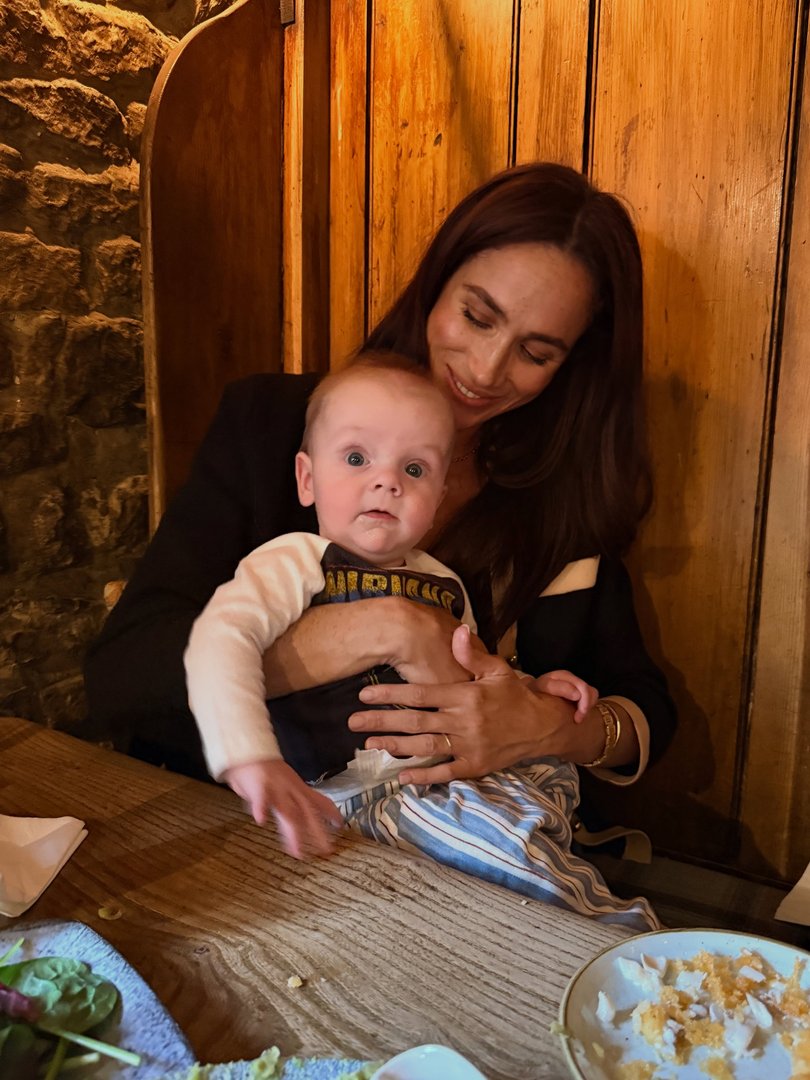 Meghan could be seen cuddling her friend's baby, Jack.