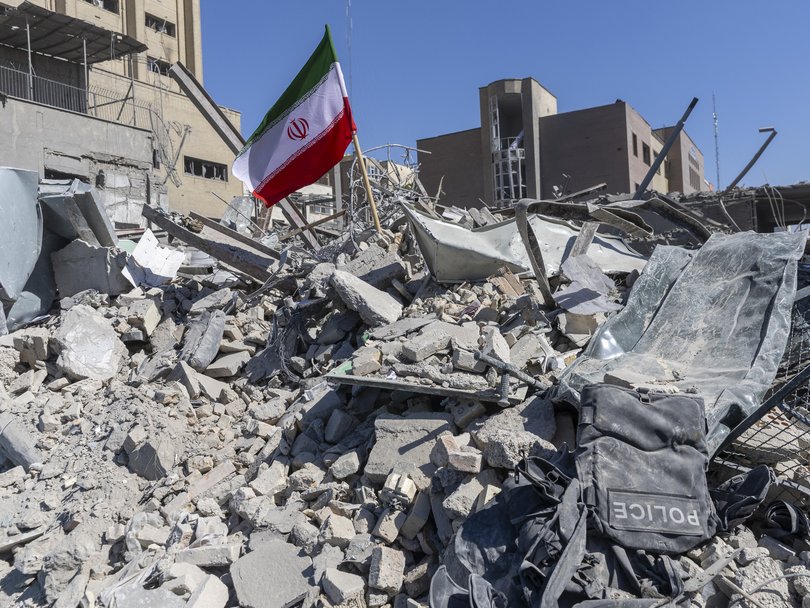 An Iranian flag in the rubble of a police station damaged by strikes in March.