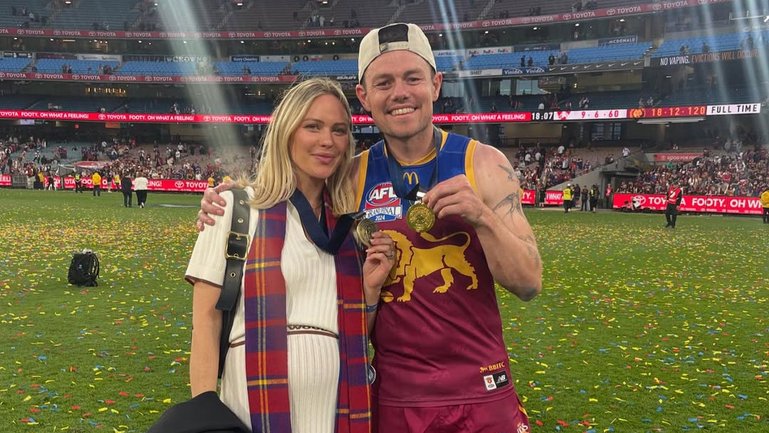 Jules Neale and Lachie Neale celebrate the Lion's premiership win in September last year.