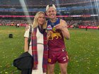 Jules Neale and Lachie Neale celebrate the Lion's premiership win in September last year.