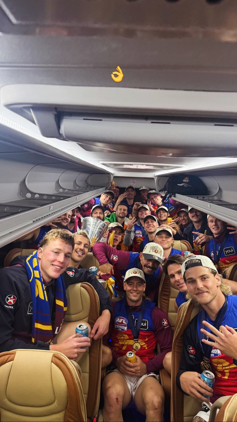 The players celebrating on the bus. 