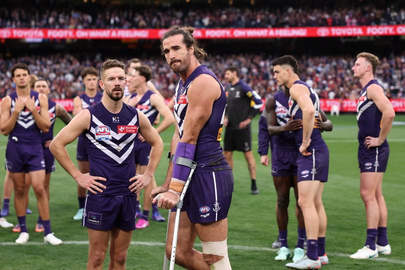 A heavy hearted Fremantle Dockers team looked out onto the stands filled with distraught fans. 