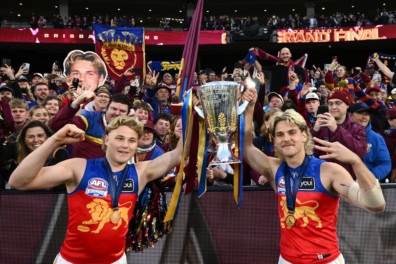 Levi (left) and Will Ashcroft celebrate their second premiership together, and Brisbane’s third straight.