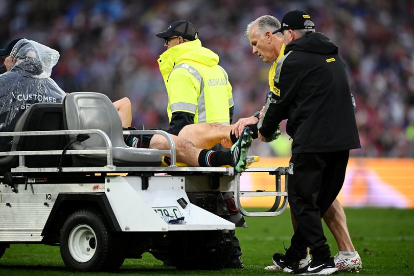 Medical staff hold the leg of Nathan Cleary in the air as he’s taken from the ground.