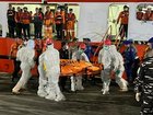 Rescue crews are working in difficult conditions to retrieve the bodies entombed in the wreck. (AP PHOTO)