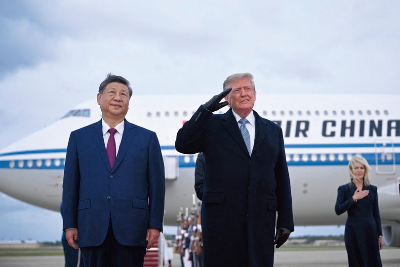 US President Donald Trump (R) salutes as he greets Chinese President Xi Jinping upon arrival at Joint Base Andrews in Maryland.