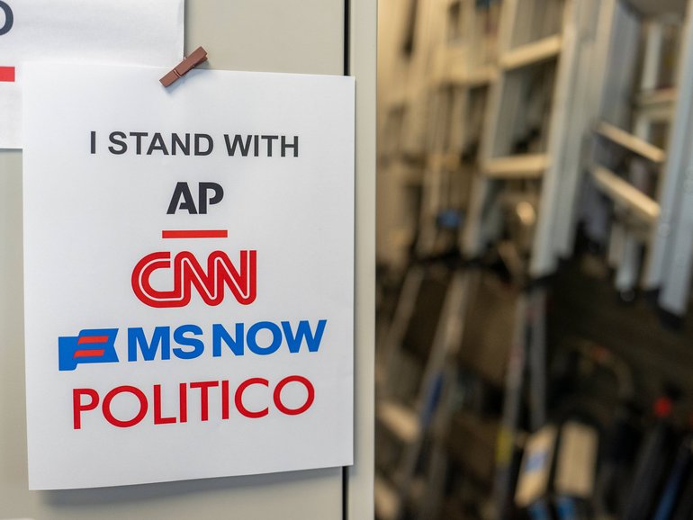 A sign in support of the banned outlets near the James S. Brady Press Briefing Room of the White House.