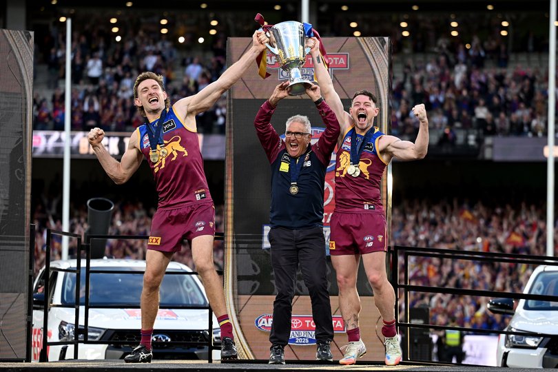Harris Andrews and Lachie Neale of the Lions celebrate with head coach Chris Fagan (centre) folllowing their win in the AFL Grand Final between the Geelong Cats and the Brisbane Lions at the Melbourne Cricket Ground in Melbourne, Saturday, September 27, 2025. (AAP Image/James Ross) NO ARCHIVING, EDITORIAL USE ONLY