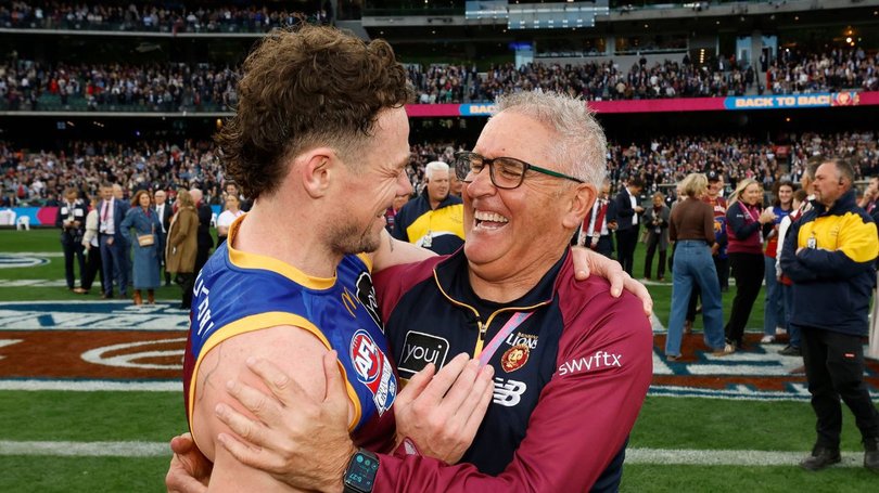 Chris Fagan embraces Lachie Neale.
