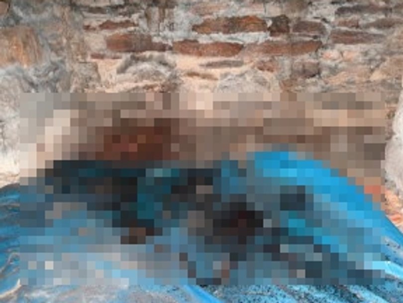 A photo showing blood pooled underneath the floor of Mr Baird’s home.