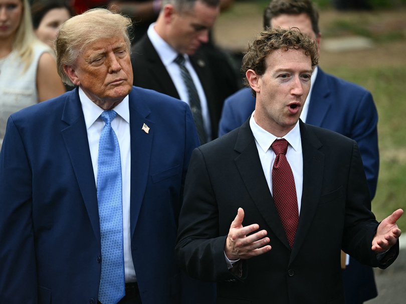 Mark Zuckerberg speaks to the press as Trump looks on.