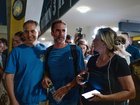 Assaf Regavim, who helped subdue the pilot during the flight, smiles as he talks with friends and relatives amidst waiting crowds at Ben Gurion Airport.