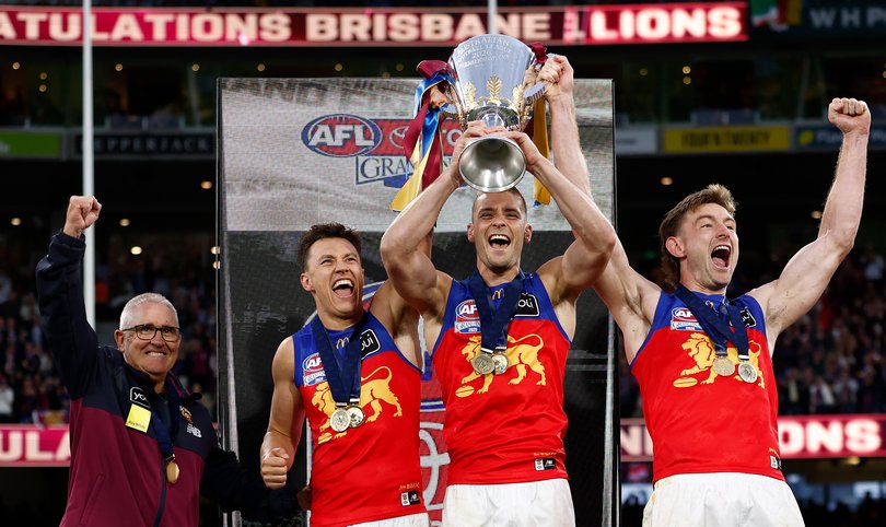 MELBOURNE, AUSTRALIA - SEPTEMBER 26: (L-R) Chris Fagan, Senior Coach of the Lions, Hugh McCluggage, Josh Dunkley and Harris Andrews of the Lions hold the Premiership Cup aloft during the AFL Grand Final match between the Fremantle Dockers and the Brisbane Lions at the Melbourne Cricket Ground on September 26, 2026 in Melbourne, Australia. (Photo by Michael Willson/AFL Photos)
