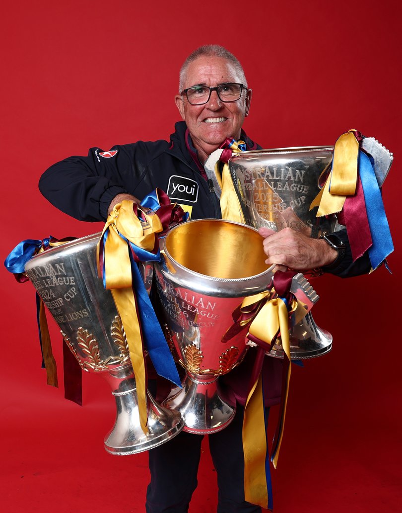 MELBOURNE, AUSTRALIA - SEPTEMBER 26: Chris Fagan, Senior Coach of the Lions poses for a photo with the premiership cups after the AFL Grand Final match between the Fremantle Dockers and the Brisbane Lions at the Melbourne Cricket Ground on September 26, 2026 in Melbourne, Australia. (Photo by James Wiltshire/AFL Photos)