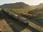 An autonomous train with iron ore crosses the Pilbara. Rio Tinto
