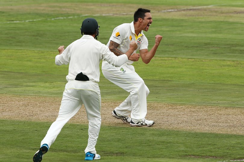Mitchell Johnson of Australia celebrates after getting the wicket of Hashim Amla.