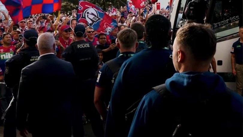 Fans cheer on the Newcastle Knights as they leave their hotel for the grand final.