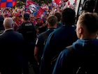 Fans cheer on the Newcastle Knights as they leave their hotel for the grand final.