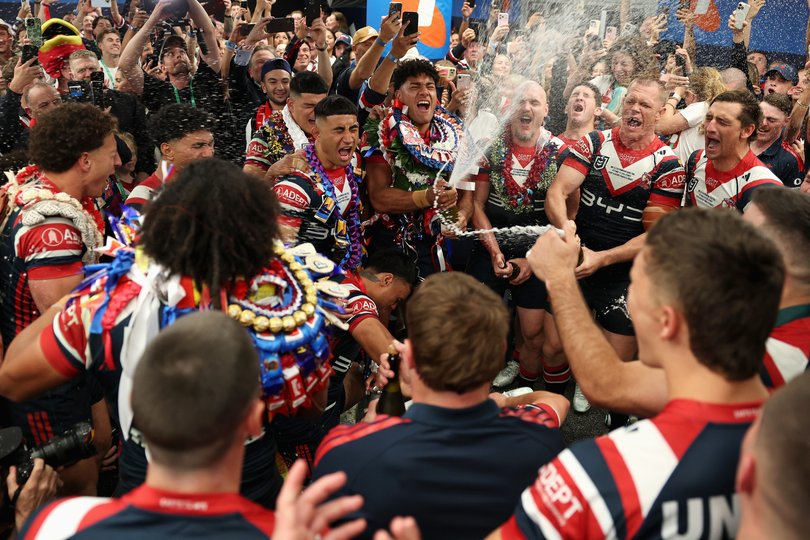 Roosters players celebrate and sing the team song in their changeroom after winning the NRL Grand Final match.