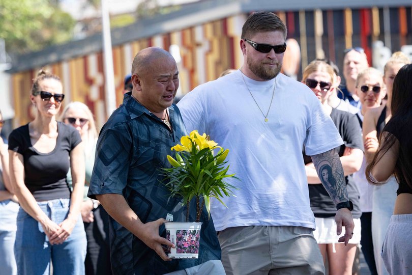 Friends and family gather in memory of Constable Mia Lay, a  New South Wales police officer who was killed on duty when the car she was travelling in crashed into a tree in Redfern. Pictured: partner Daniel Vasquez (white shirt) with Mia’s father Clem.