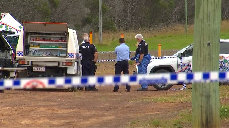 Police and forensic officers examine the scene where a man was found dead on Wednesday morning.