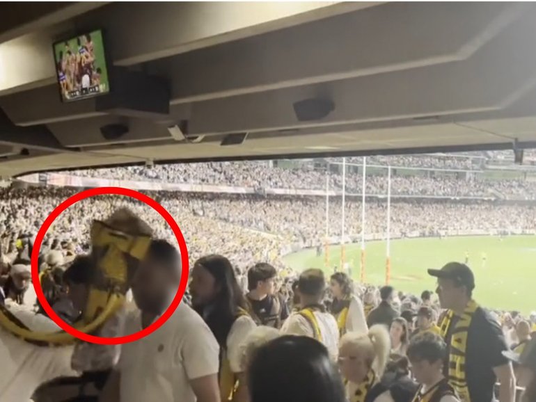 A mother and her young son were seated in the grandstands at the MCG when the food was allegedly thrown at them.