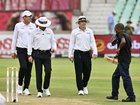 Umpires check the light during day 1.