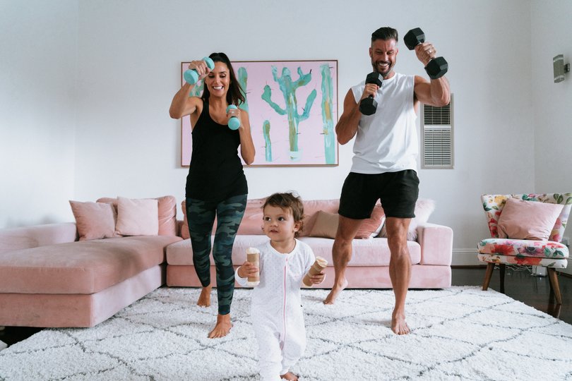 Left: Sam Wood. Below: Wood exercising at home with his wife Snezana Wood and their daughter Willow Wood.