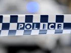 Victoria Police have arrested a man after officers found a dead body at an apartment complex in Carlton in the early hours of Saturday morning.