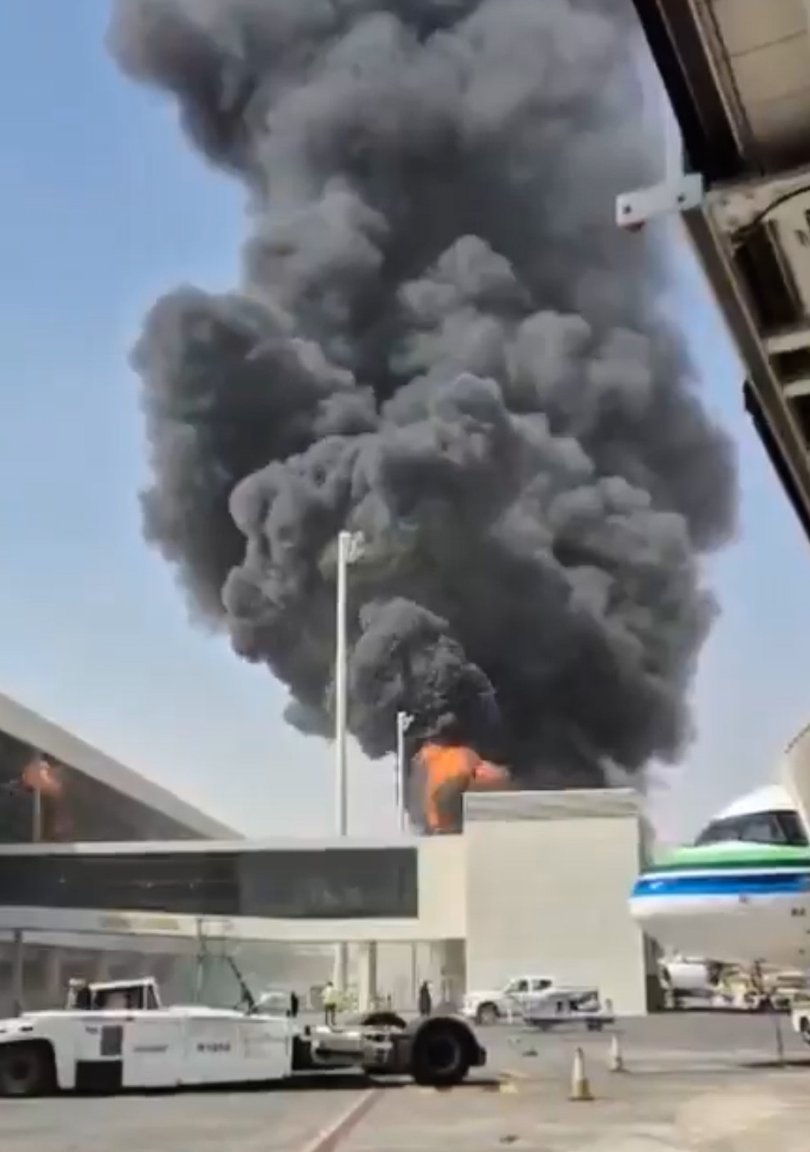 This image from video obtained and verified by AP shows thick black smoke and flames rising from a fire at King Khalid International Airport in Riyadh.