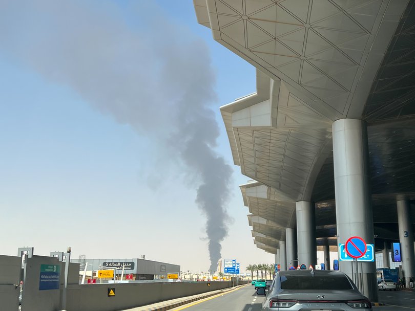 A mobile phone photo shows thick smoke rising near the airport in the Saudi capital.