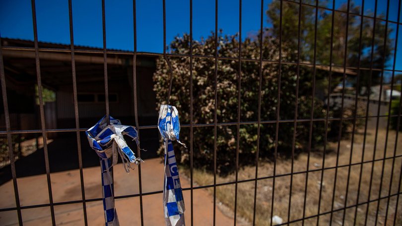 The burnt former home of Margaret Hawke and her three children is fenced off back in December 2022.