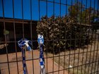 The burnt former home of Margaret Hawke and her three children is fenced off back in December 2022.