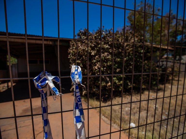 The burnt former home of Margaret Hawke and her three children is fenced off back in December 2022.