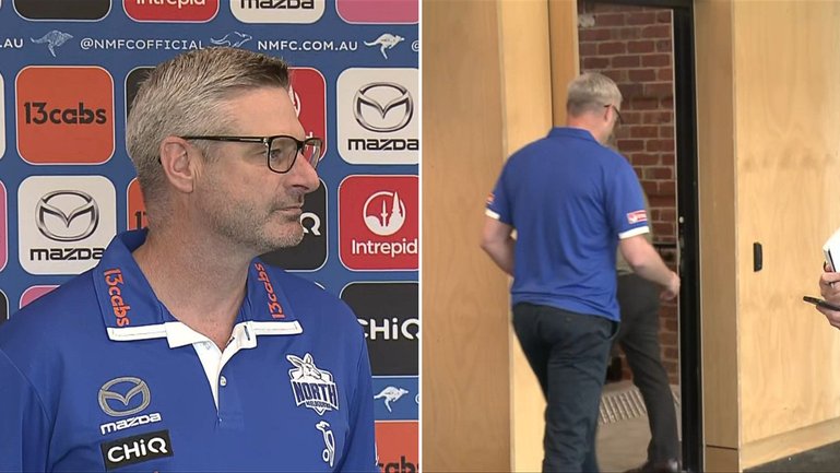 North Melbourne list manager Brady Rawlings walks out of the press conference after journalist’s curly question.