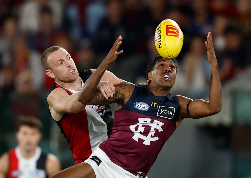 Callum Wilkie of the Saints and Keidean Coleman of the Lions compete for the ball.