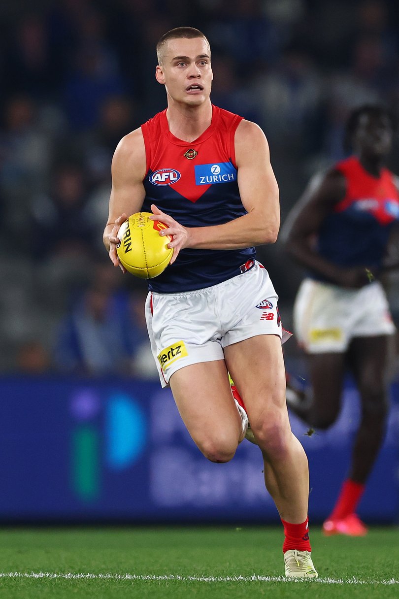 Trent Rivers of the Demons runs with the ball.