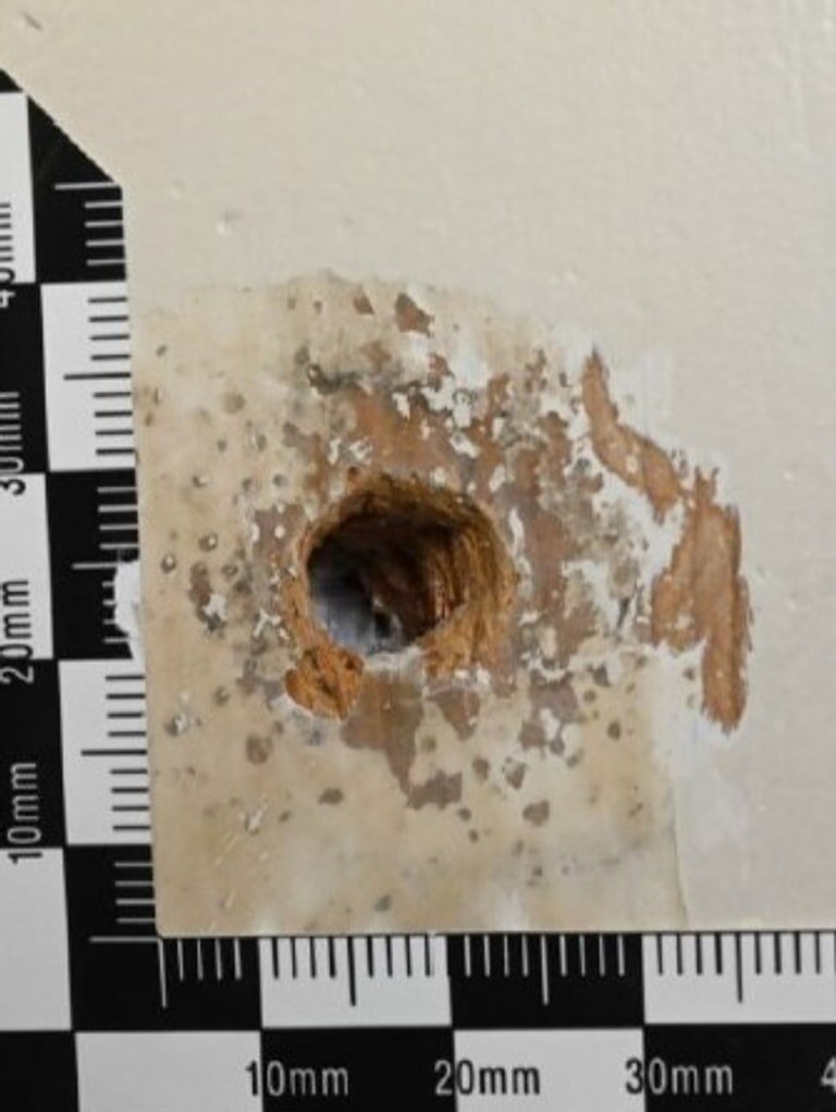 Close view of the bullet hole in Mr Baird’s door with paint and putty removed. Picture: Court exhibit.