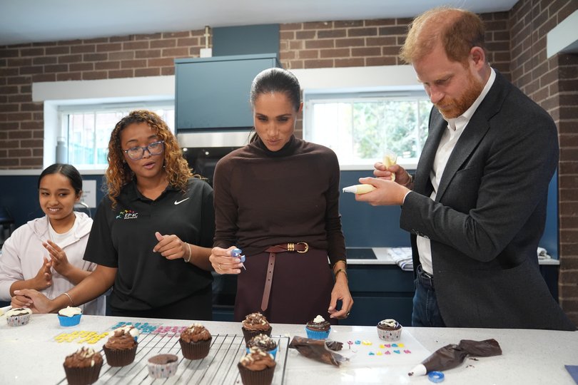 Meghan, Duchess of Sussex and Prince Harry, Duke of Sussex decorate cupcakes at Epic Partners during their visit to Nottingham.