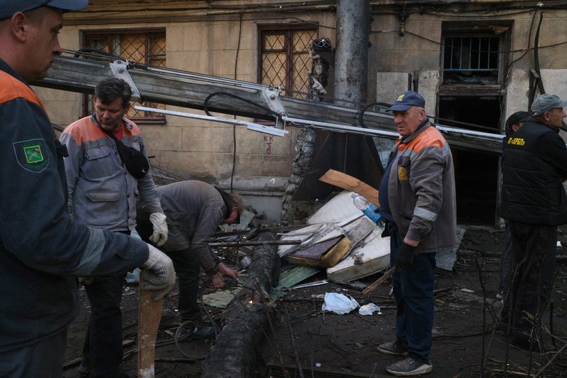 Residents collect  belongings from an apartment the day after an attack in Kharkiv, northern Ukraine, on October 13, 2026.