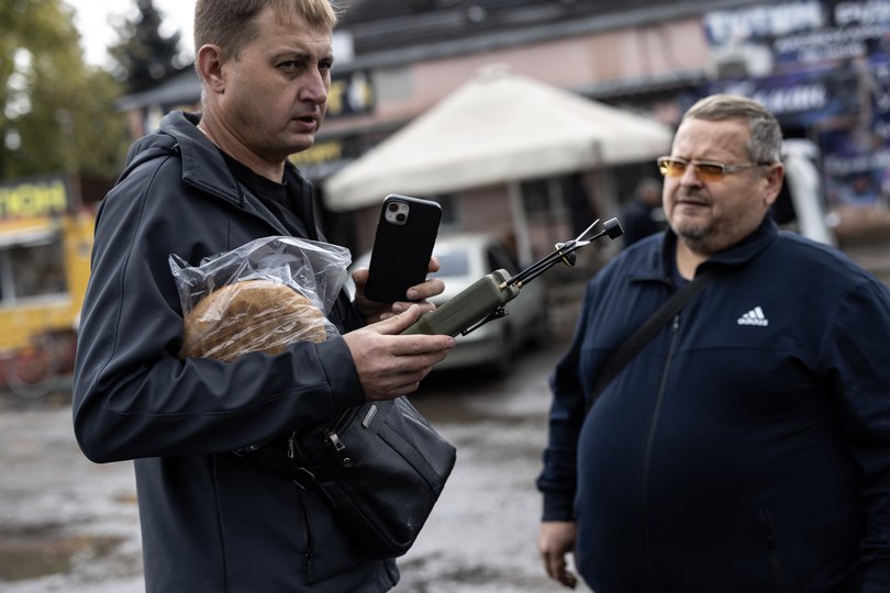 Volodymyr Cherkasov, left, holds a Dzyga drone detector.